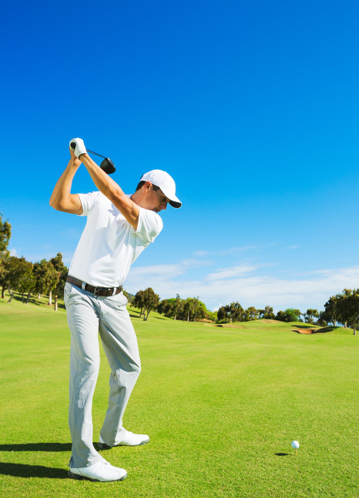 Golfer Hitting Golf Shot with Club on the Course